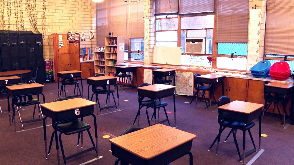 Classroom with empty desks spaced out.