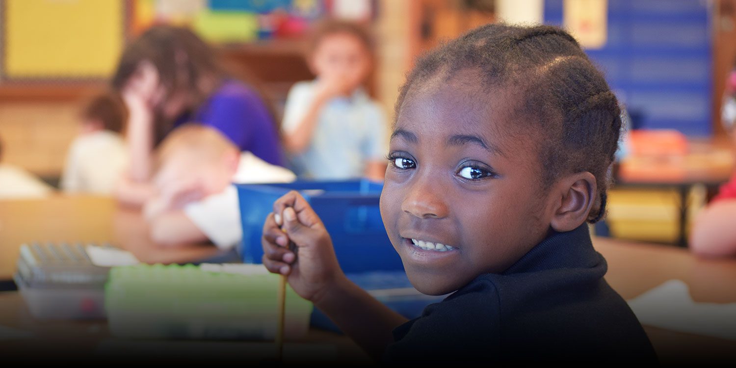 Student smiling in a classroom