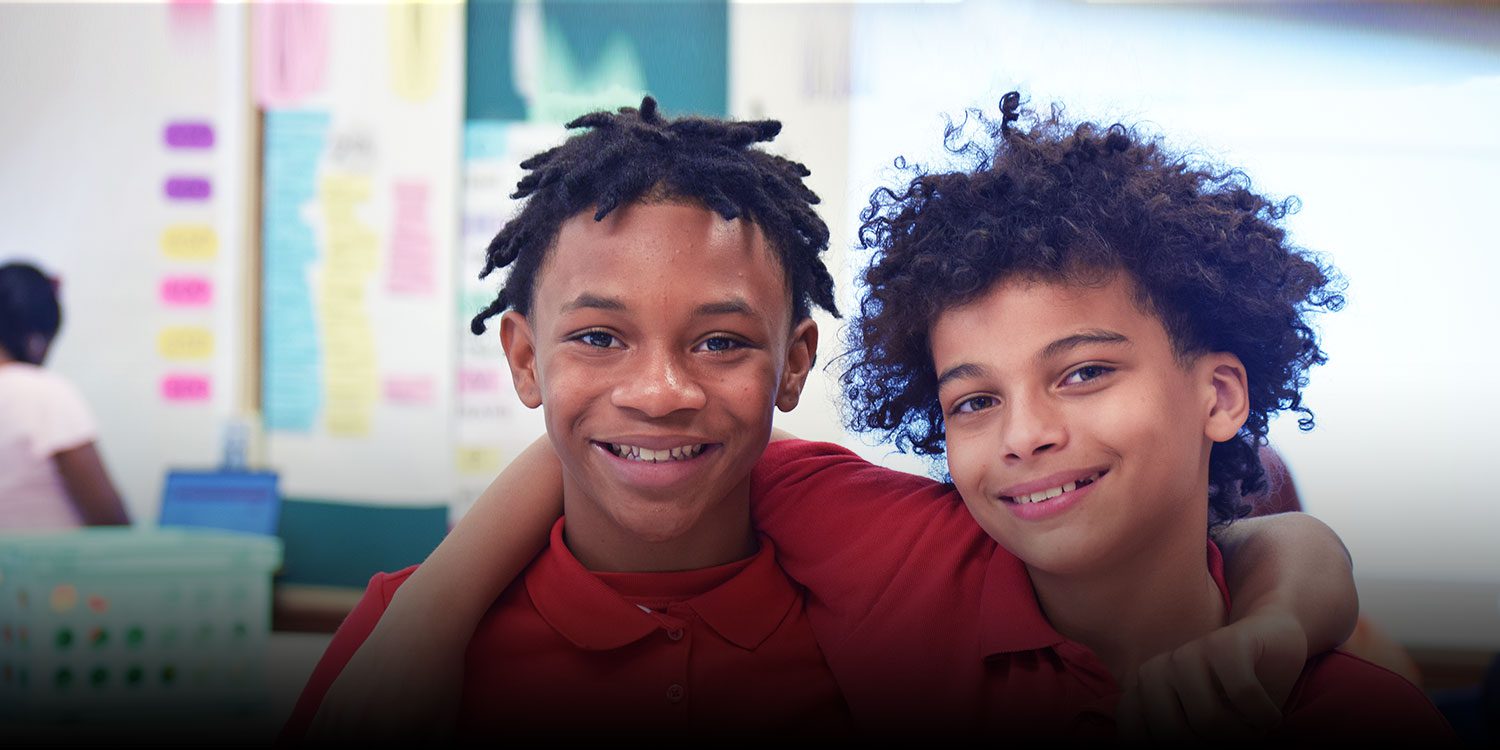 Smiling students with their arms around each other
