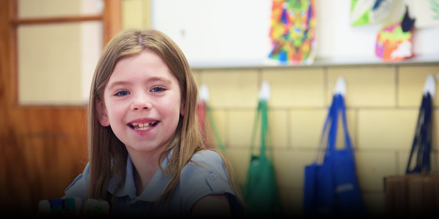 Student smiling in a classroom